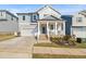 Inviting two-story home featuring a classic covered front porch, well-manicured lawn, and attached garage at 1417 Underbrush Dr, Durham, NC 27703