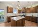 Modern kitchen with stainless steel appliances, a kitchen island, and hardwood flooring, ideal for cooking and entertaining at 1417 Underbrush Dr, Durham, NC 27703