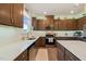 Stylish kitchen with stainless steel appliances, white countertops, and dark wood cabinetry, with bright natural light at 1417 Underbrush Dr, Durham, NC 27703