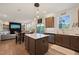 Open kitchen concept flows into a dining area and living space with a TV and fireplace, perfect for modern living at 1417 Underbrush Dr, Durham, NC 27703