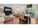Open-concept living area with fireplace, dining table, and access to a screened patio for seamless indoor-outdoor living at 1417 Underbrush Dr, Durham, NC 27703