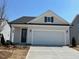 Charming home featuring a two-car garage, inviting entrance and manicured front lawn at 173 Little Crk Dr, Lillington, NC 27546