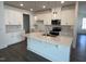 Open kitchen featuring white cabinetry, stainless appliances, and a large center island at 173 Little Crk Dr, Lillington, NC 27546