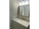 Bathroom featuring a light gray vanity with a white countertop and wooden-trimmed mirror at 176 Clear Water Dr, Smithfield, NC 27577