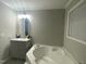 Bright bathroom featuring a modern tub and vanity at 176 Clear Water Dr, Smithfield, NC 27577
