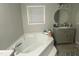 Bathroom featuring a garden tub, gray walls, and a light gray vanity at 176 Clear Water Dr, Smithfield, NC 27577
