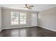 Bright living room with large windows, hardwood flooring, and a ceiling fan at 176 Clear Water Dr, Smithfield, NC 27577