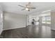 Open-concept living area with hardwood floors, ceiling fan, and abundant natural light at 176 Clear Water Dr, Smithfield, NC 27577