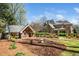 Large backyard featuring a playhouse, garden, manicured landscaping, and rear view of the home at 2207 Oxford Rd, Raleigh, NC 27608