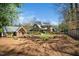 Large backyard featuring a playhouse, garden, mature landscaping, and rear view of the home at 2207 Oxford Rd, Raleigh, NC 27608
