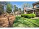 A sprawling backyard offers manicured lawn, mature landscaping, and a covered patio, perfect for outdoor living at 2207 Oxford Rd, Raleigh, NC 27608