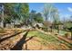Well-maintained backyard featuring a playhouse, small arbor, garden, and mature landscaping at 2207 Oxford Rd, Raleigh, NC 27608