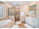 Stunning bathroom featuring a glass-enclosed shower, soaking tub, and vanity with marble counters for an opulent retreat at 2207 Oxford Rd, Raleigh, NC 27608
