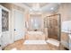 Luxurious bathroom featuring a soaking tub, glass-enclosed shower, and tiled flooring at 2207 Oxford Rd, Raleigh, NC 27608