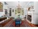 Elegant dining room featuring a glass-top table, fireplace, and large windows with views of the outdoors at 2207 Oxford Rd, Raleigh, NC 27608