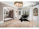 Grand foyer featuring a black piano, elegant rug, and arched doorways leading to other areas of the home at 2207 Oxford Rd, Raleigh, NC 27608