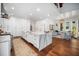 Bright, modern kitchen with an expansive island, white cabinetry, and stainless steel appliances, perfect for entertaining at 2207 Oxford Rd, Raleigh, NC 27608