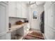 Well-organized laundry room with marble counters, custom cabinets, and modern washer/dryer unit for convenience at 2207 Oxford Rd, Raleigh, NC 27608