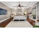 Serene primary bedroom with hardwood floors, tray ceiling, and a seating area for relaxation at 2207 Oxford Rd, Raleigh, NC 27608