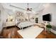 Serene primary bedroom with hardwood floors, tray ceiling, and a seating area for relaxation at 2207 Oxford Rd, Raleigh, NC 27608