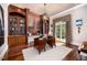 Spacious home office with custom wood built-ins, a classic desk, hardwood floors, and a bright window at 2207 Oxford Rd, Raleigh, NC 27608