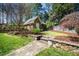 Backyard featuring an outbuilding, stone steps and retaining wall, and mature landscaping at 2207 Oxford Rd, Raleigh, NC 27608