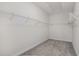 Walk-in closet ready for organization, featuring wire shelving and neutral carpeting at 228 Nahunta Dr, Apex, NC 27539
