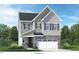 Charming two-story home featuring stone accents, gray siding, and a two-car garage for modern curb appeal at 228 Nahunta Dr, Apex, NC 27539