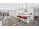 Bright kitchen with white cabinets, stainless steel appliances, and a center island with bar seating at 228 Nahunta Dr, Apex, NC 27539