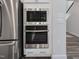 Stainless steel microwave and oven appliances in a modern kitchen with white cabinets at 228 Nahunta Dr, Apex, NC 27539