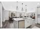 Spacious kitchen featuring a large island, stainless steel appliances, and an open view into the dining and living area at 228 Nahunta Dr, Apex, NC 27539