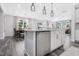 Kitchen island with stainless steel dishwasher and an open layout view of the dining and living area at 228 Nahunta Dr, Apex, NC 27539