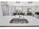 Stainless steel kitchen sink in a modern kitchen with white cabinets and an open concept layout at 228 Nahunta Dr, Apex, NC 27539