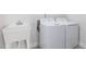 Functional laundry room with a washing machine, dryer, and a utility sink at 228 Nahunta Dr, Apex, NC 27539
