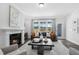 Living room showcasing a fireplace, comfortable seating, and large windows offering scenic views at 228 Nahunta Dr, Apex, NC 27539