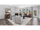 Bright living room with a fireplace, neutral decor, and a view of the outdoors through large windows at 228 Nahunta Dr, Apex, NC 27539