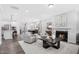 Spacious open-concept living room with hardwood floors and access to an adjacent modern kitchen at 228 Nahunta Dr, Apex, NC 27539