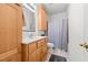 Well-lit bathroom featuring a vanity with storage, a decorative mirror, and a shower and tub combo at 23901 Nc-902, Bennett, NC 27208