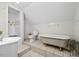 Bright bathroom with traditional tub, toilet, and sink at 23901 Nc-902, Bennett, NC 27208