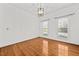 Bedroom with hardwood floors, and two windows with a light fixture at 23901 Nc-902, Bennett, NC 27208