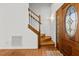 Welcoming entryway with a wooden staircase, and a decorative front door at 23901 Nc-902, Bennett, NC 27208