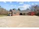 Exterior view of home with a metal roof, white trim, and a circular driveway at 23901 Nc-902, Bennett, NC 27208