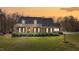 Charming brick home featuring a metal roof, manicured bushes, and a well-maintained front yard at 23901 Nc-902, Bennett, NC 27208