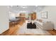 Spacious living room with a ping pong table and hardwood flooring flowing into an open kitchen at 23901 Nc-902, Bennett, NC 27208