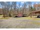 A storage building with a gravel lot and bare winter trees at 23901 Nc-902, Bennett, NC 27208