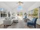 Bright sunroom with multiple windows, high ceilings, and comfortable seating areas at 23901 Nc-902, Bennett, NC 27208