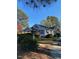 A charming home with a lush front yard, and a covered porch, perfect for enjoying the outdoors at 249 Bailey'S Crossroads Rd, Benson, NC 27504