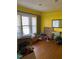 Bright living room featuring hardwood floors, large windows, and yellow walls at 249 Bailey'S Crossroads Rd, Benson, NC 27504