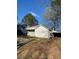 A white outbuilding with a garage at 249 Bailey'S Crossroads Rd, Benson, NC 27504