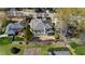 Aerial perspective of the backyard featuring a screened porch, mature trees, and manicured landscaping at 2704 St Marys St, Raleigh, NC 27609